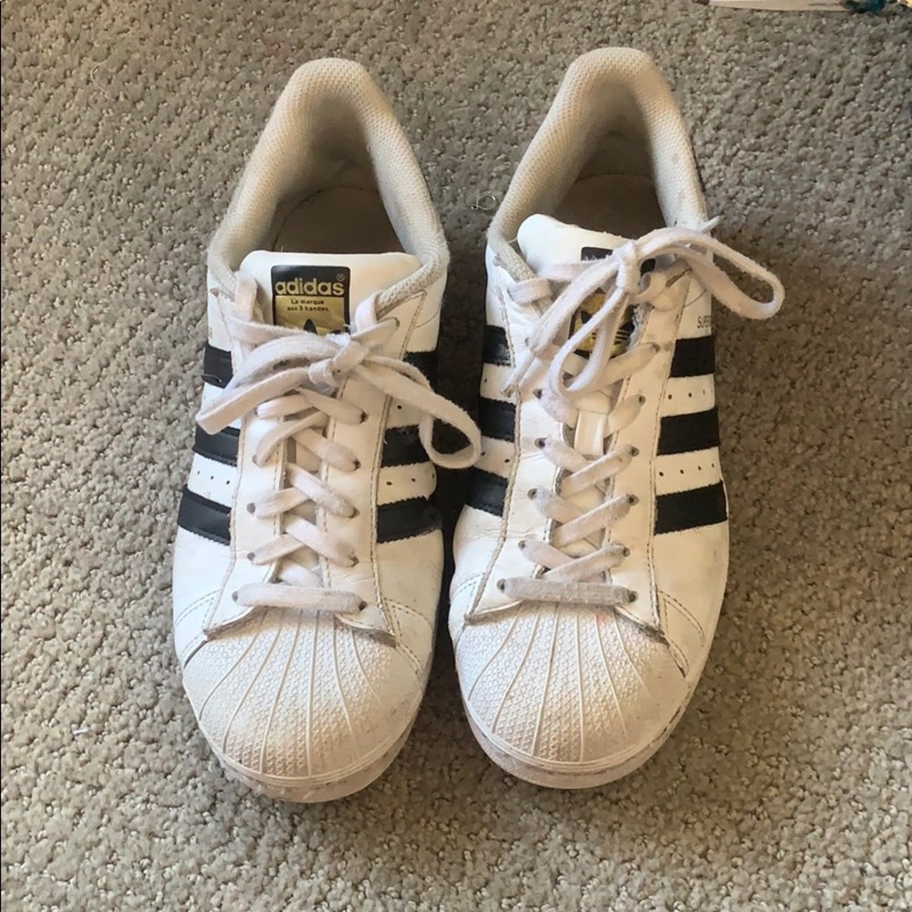 White adidas superstars with black stripes